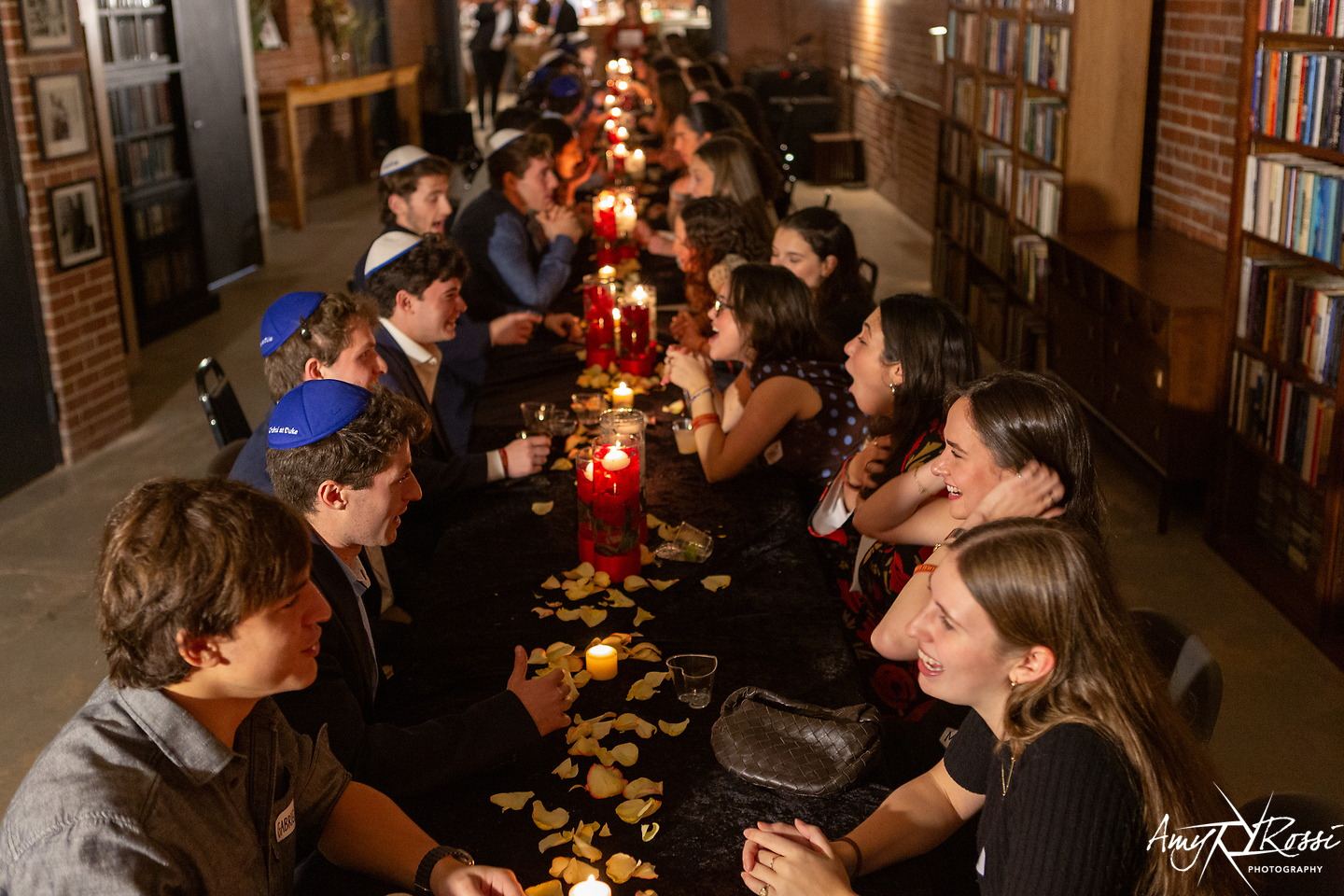 A long candlelit dinner table at the Chabad formal