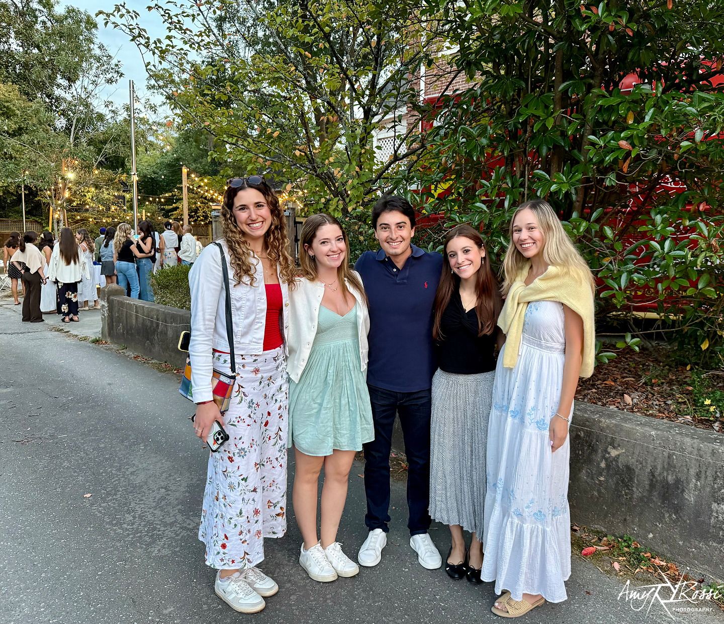 Students in golden evening light outside the Fleishman House