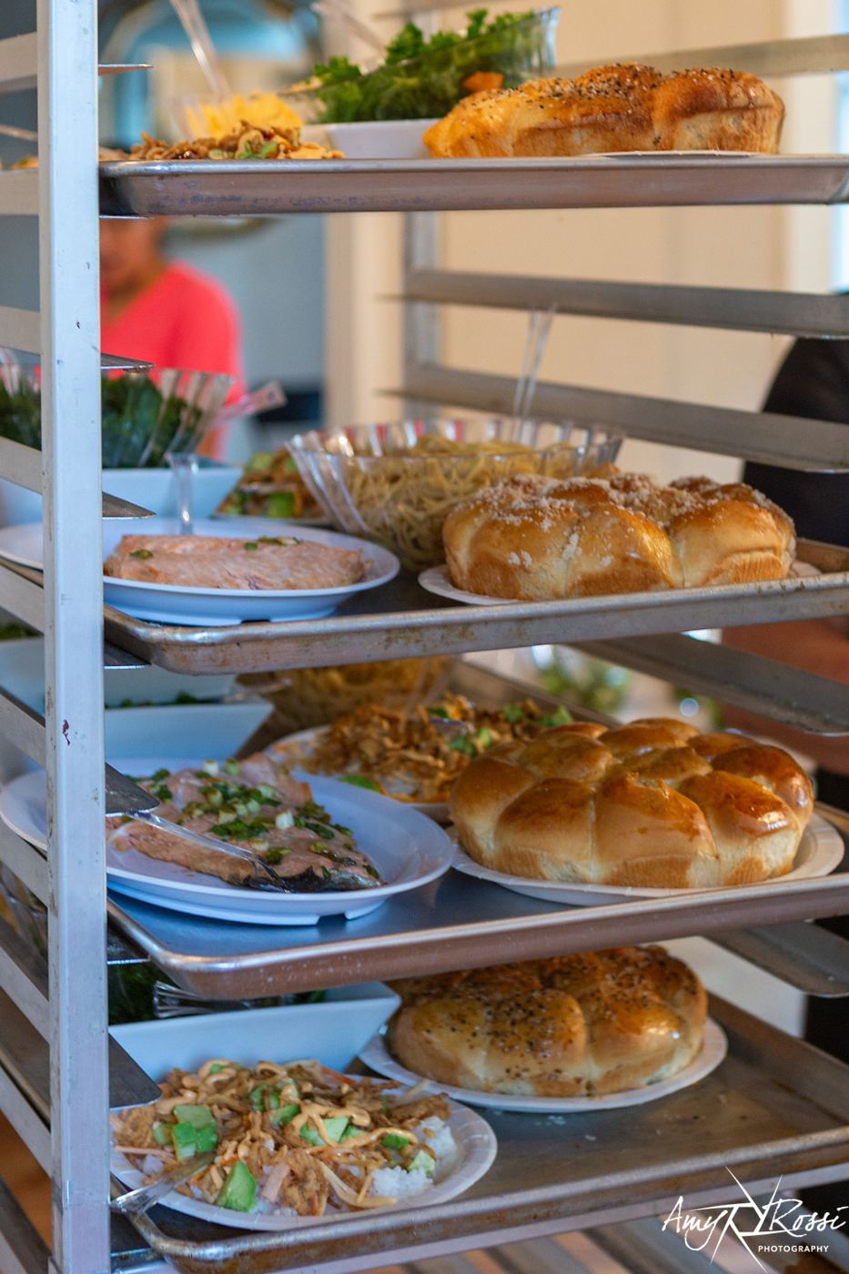 Fresh challahs stacked on the kitchen cart